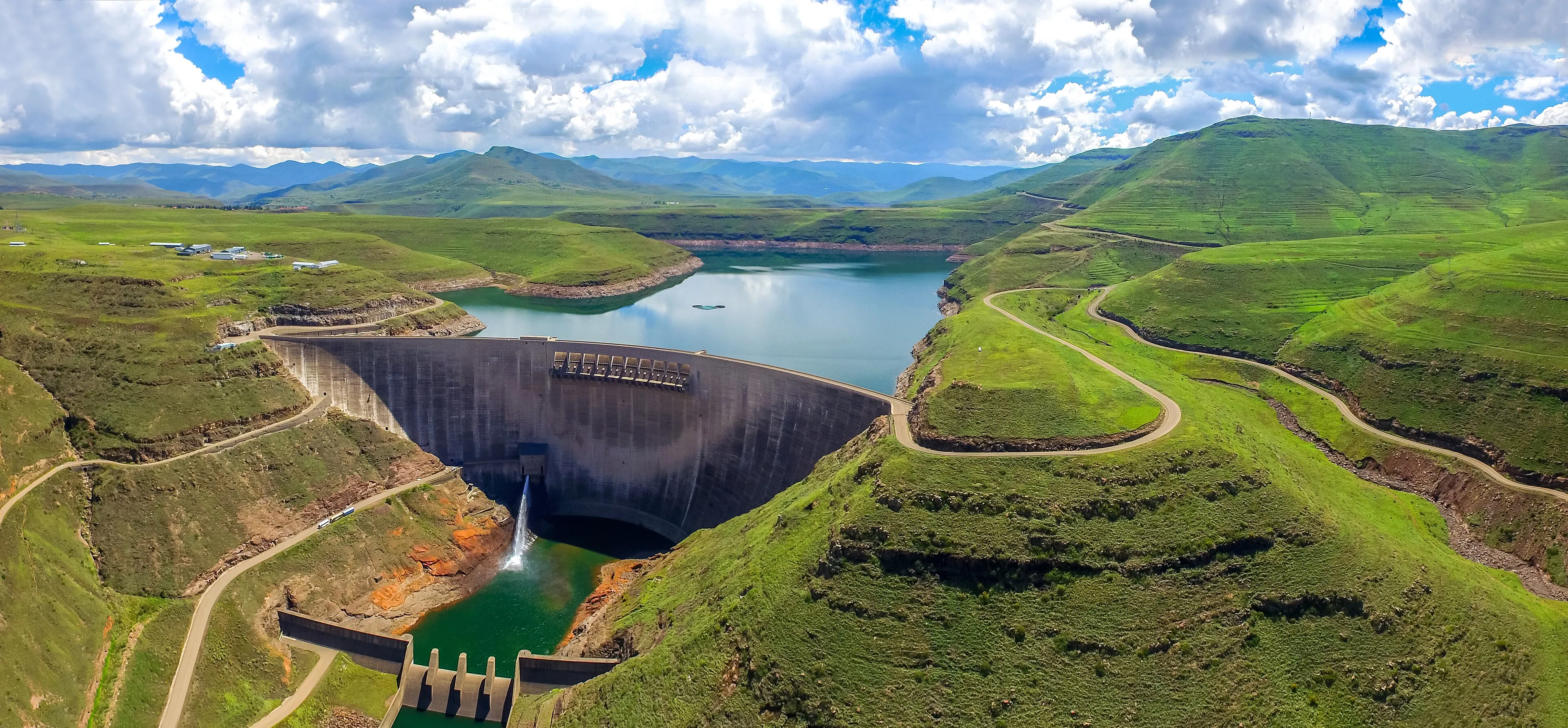 A dam surrounded by green hills